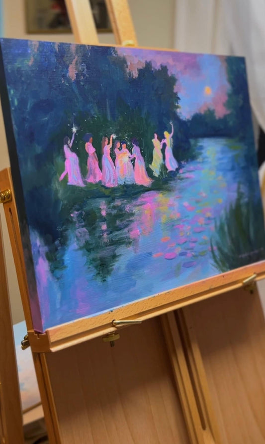 May include: A painting on a wooden easel depicting a group of women in flowing pink dresses standing in a circle around a body of water. The water is a light blue color with pink and purple reflections. The background is a dark green forest with a bright yellow moon in the sky.